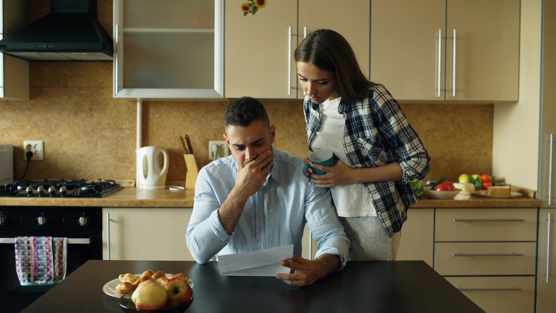 couple reviewing bill at kitchen table